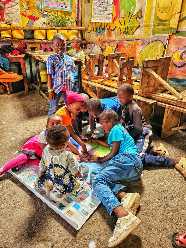 Children playing a board game together on the floor