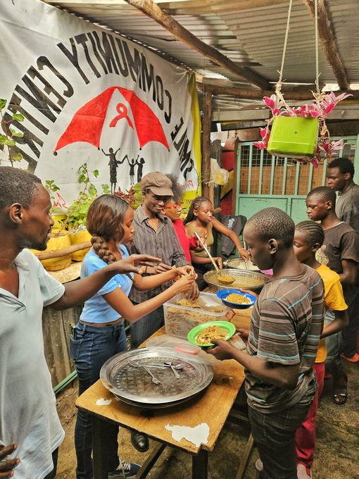 Volunteers serving food to children at the centre