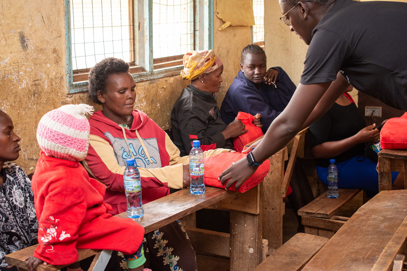 A caregiver receiving a food package at sign-out