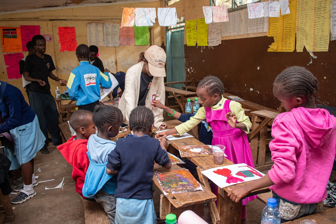 Children gathered around a table of materials