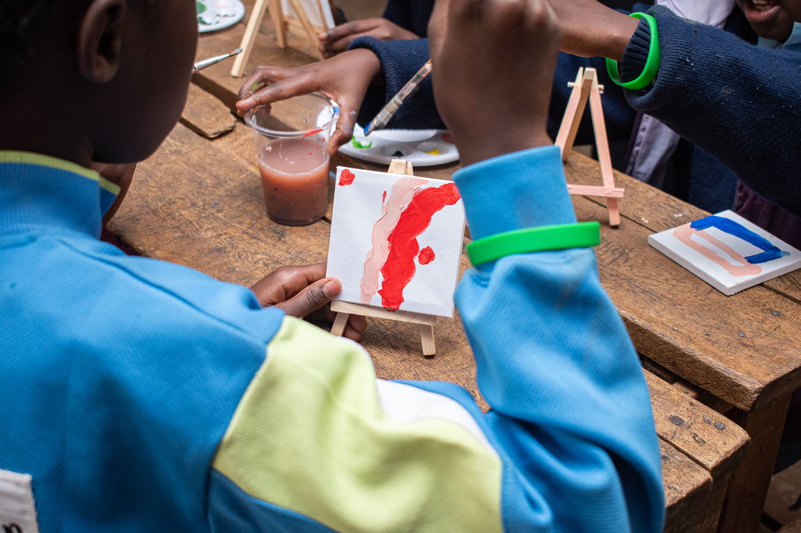 A young child colouring at a desk
