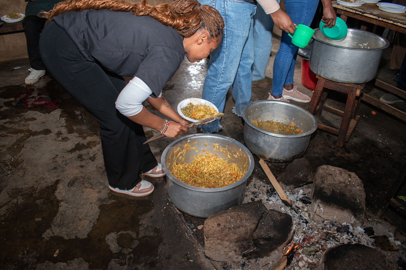 Volunteers serving a hot meal cooked on site