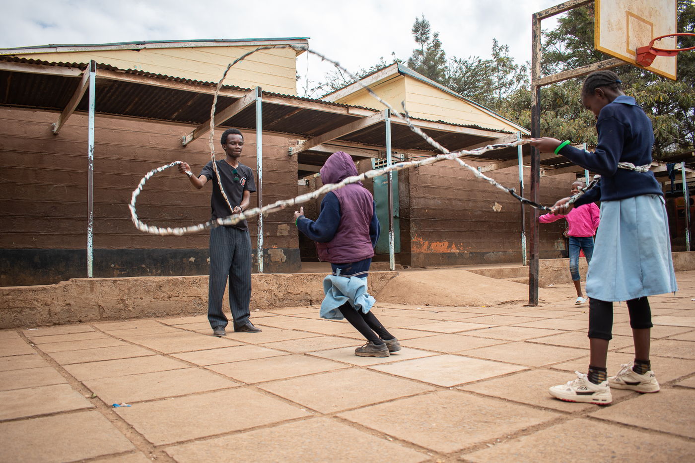 Children playing outdoors with a skipping rope