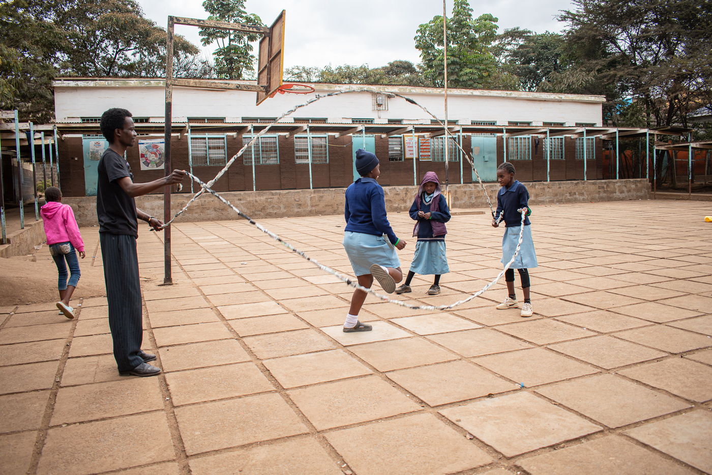 A child skipping in the school courtyard