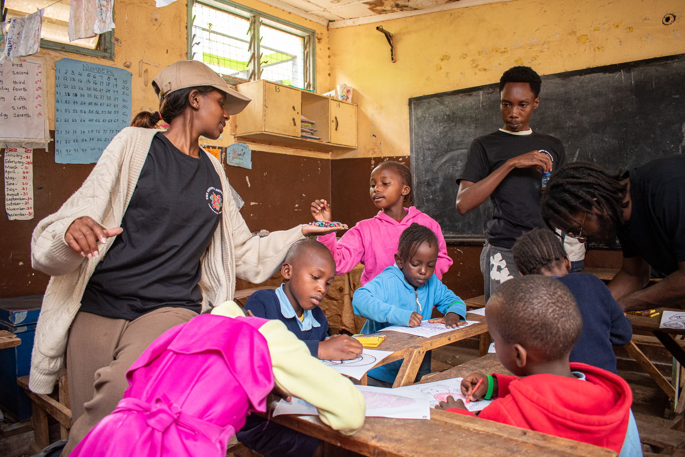 An adult volunteer helping a child at a desk